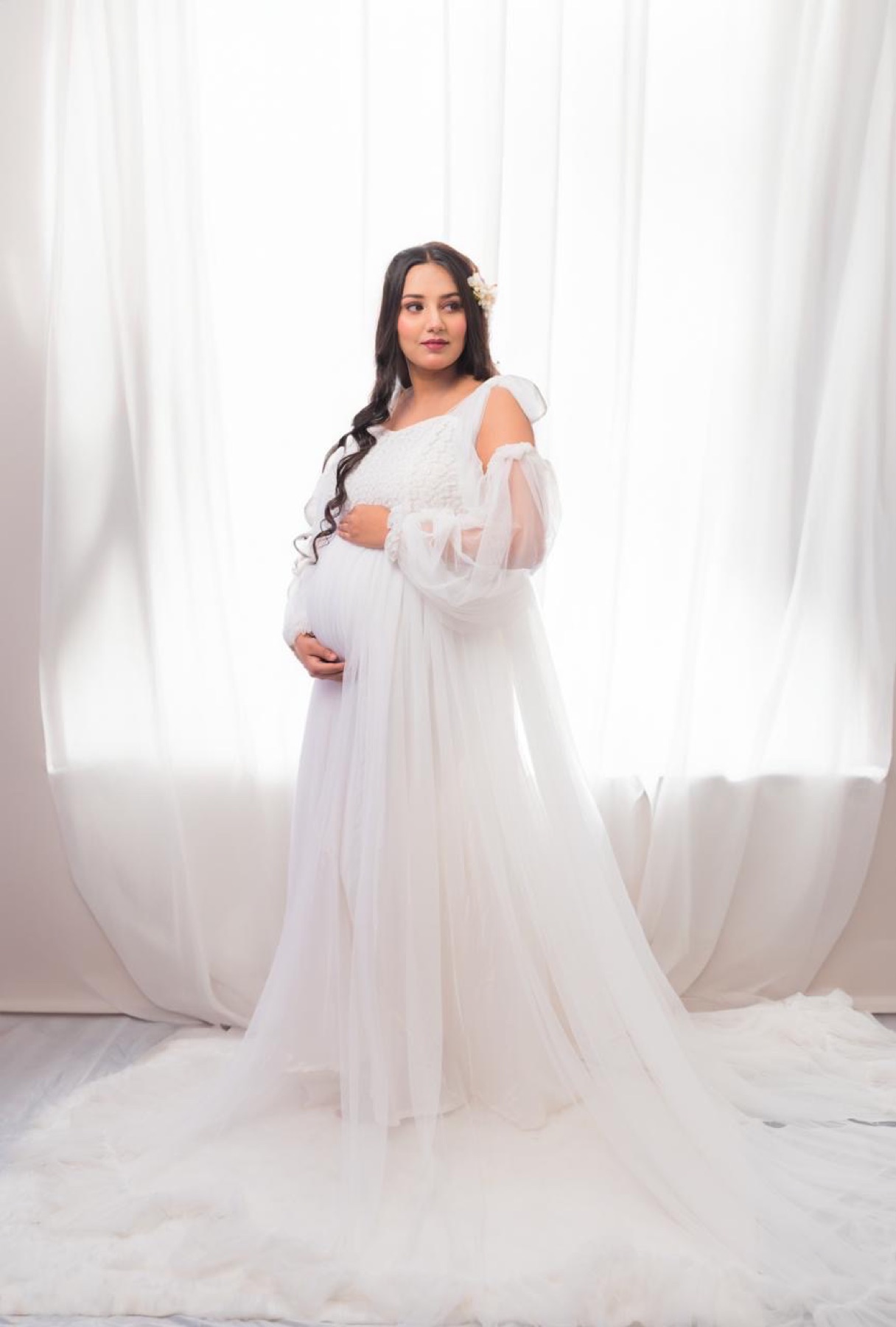 White gown full length maternity portrait with soft curtain backdrop